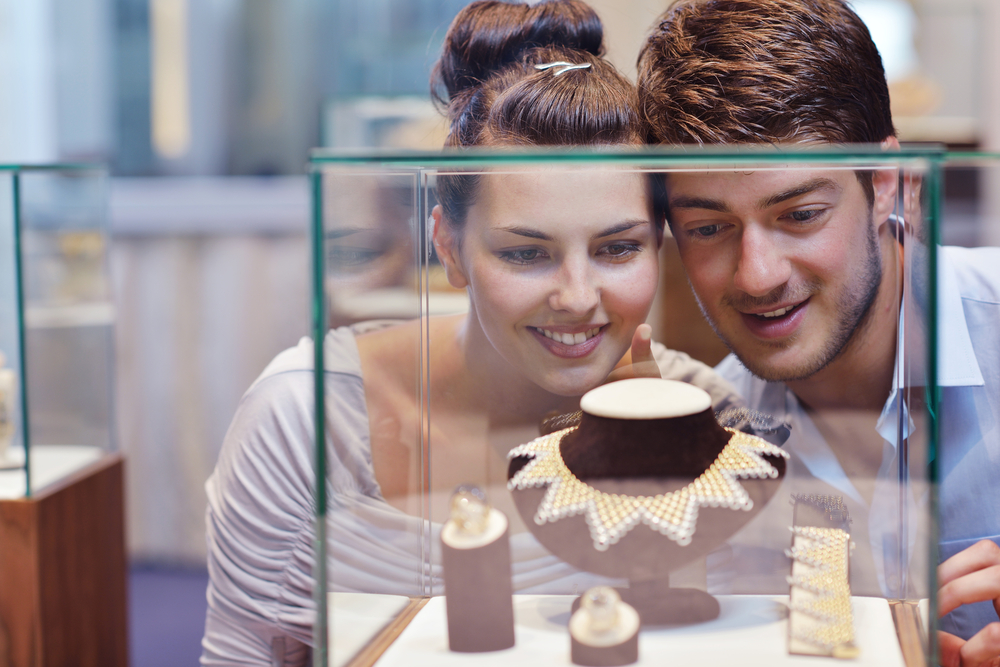 happy young romantic couple in love buy jewelry ring in luxury store